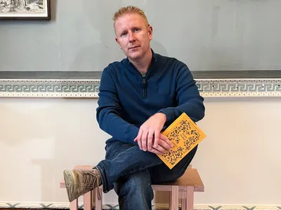 Brian Cleary poses with a newly published copy of Bram Stoker&#39;s &quot;Gibbet Hill,&quot; illustrated by&nbsp;Irish artist Paul McKinley.