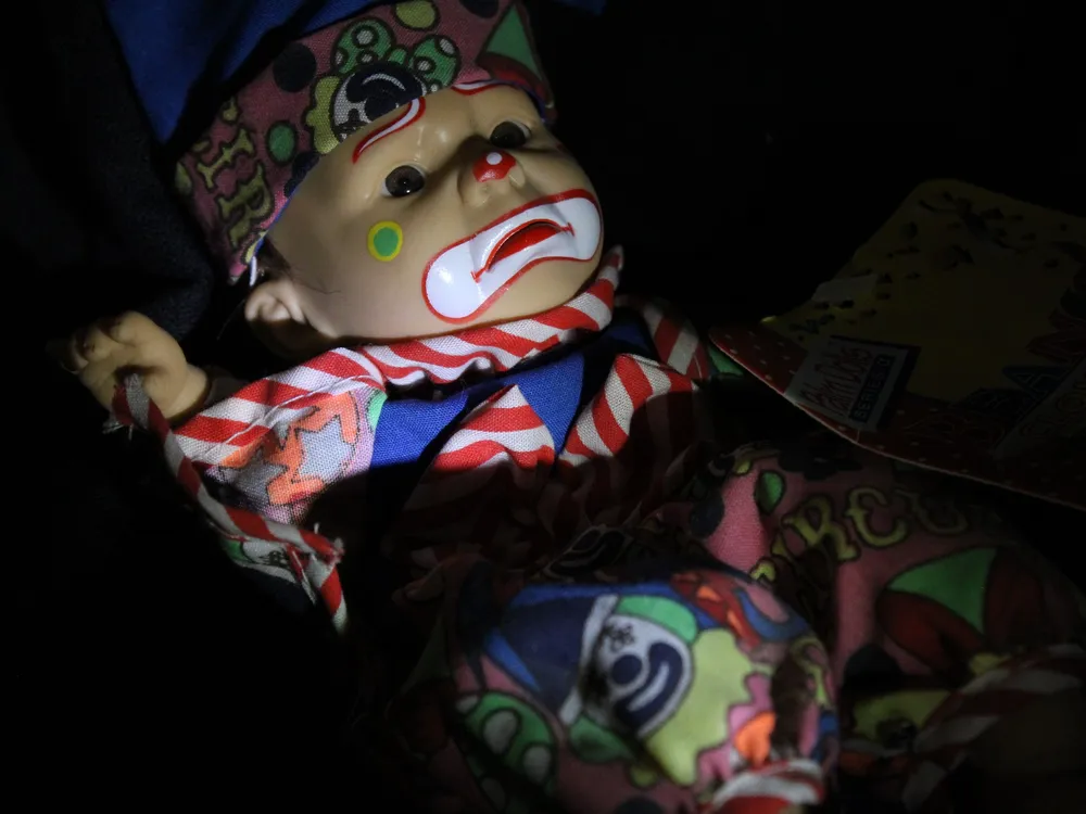 Spooky doll with clown makeup on