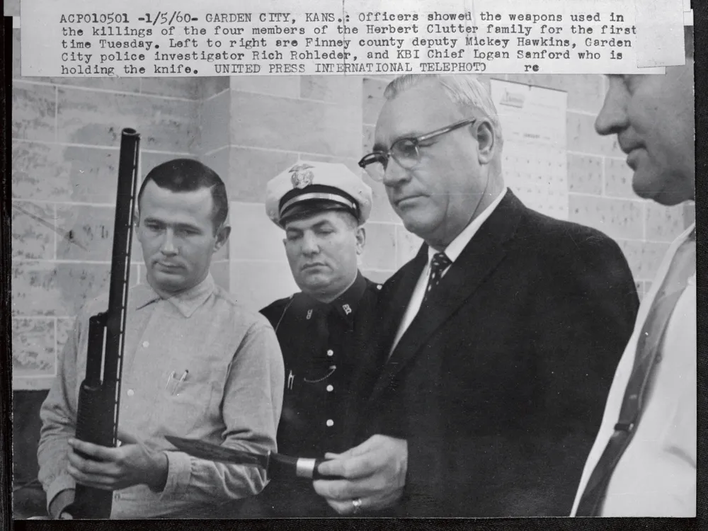 Officers display shotgun and knife used in the killings of the four members of the Herbert Clutter family