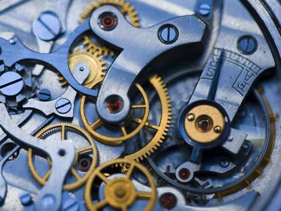 Gears turn inside an antique watch.