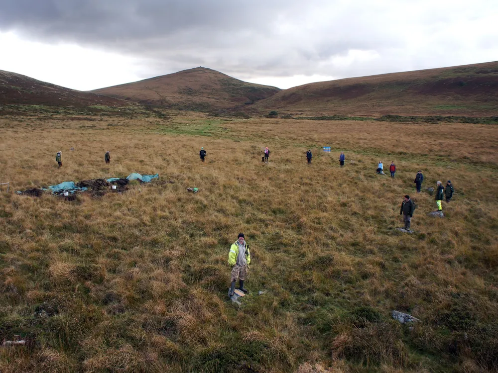 The team stands around the Metheral stone circle