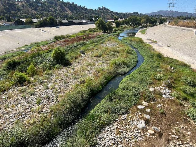 A view of the soft-bottomed Los Angeles River below the 400-foot-long Taylor Yard Bridge in Elysian Valley. The newest Taylor Yard parcel, currently fenced off as it undergoes toxic remediation, can be seen on the far right.